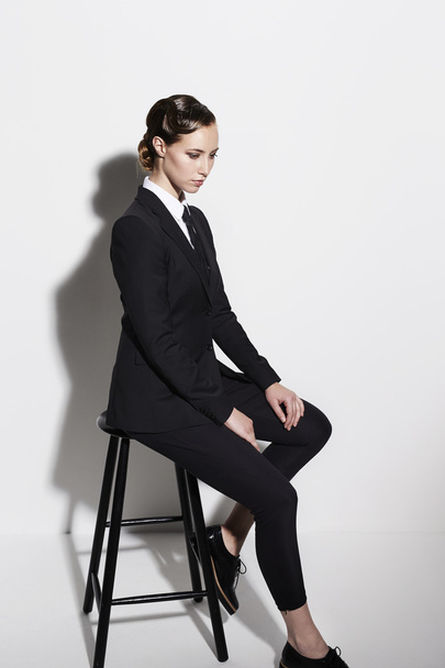 Businesswoman sitting on stool - Zdjęcie, obraz