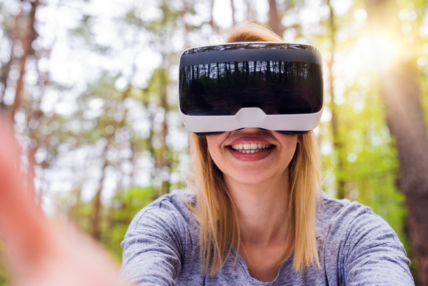 Woman wearing virtual reality goggles  - Фото, зображення