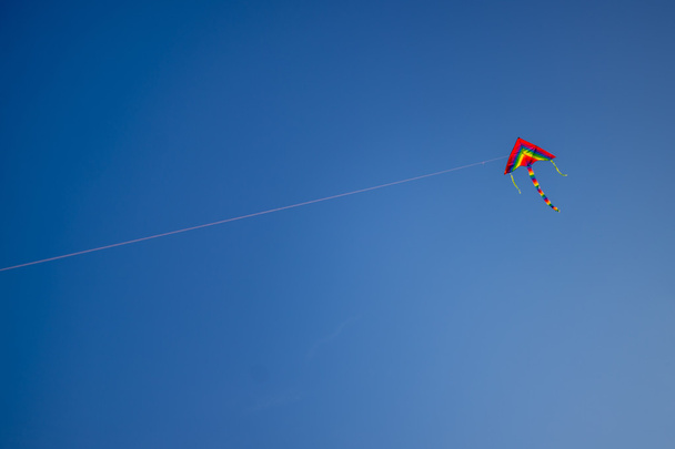 Coloured kite on a background of blue sky. Space for text - Photo, image
