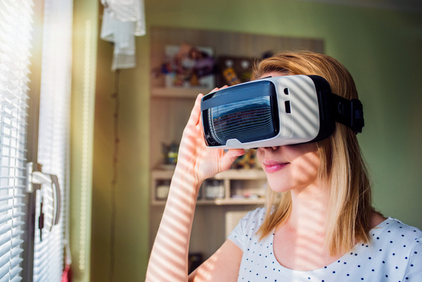 Woman wearing virtual reality goggles  - Фото, зображення