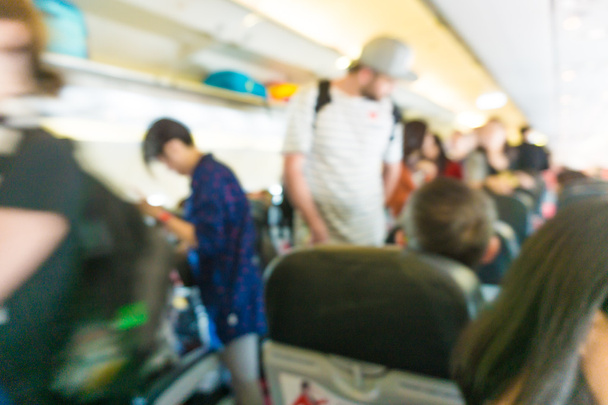 Blurred background Interior of airplane with passengers on seats - Photo, Image