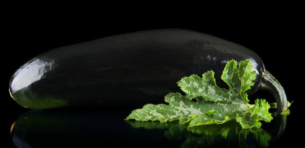 Closeup photo of zucchini on black background - Foto, Bild