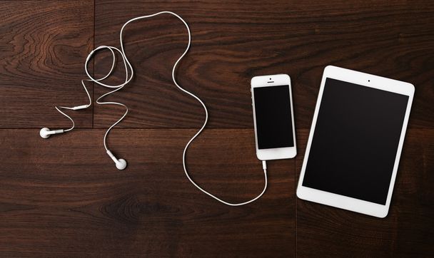 Smartphone and tablet with earphones - Foto, imagen