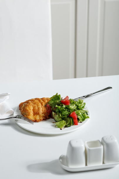 Carne fritta con insalata sul tavolo bianco. Immagine stock
 - Foto, immagini