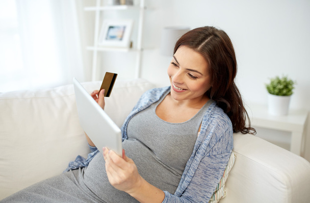 pregnant woman with tablet pc and credit card - Photo, image
