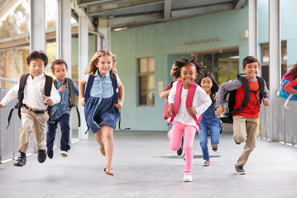 Group of kids running in a school corridor - Foto, imagen