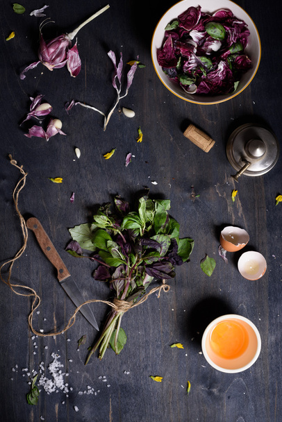 Fresh radicchio salad with summer garden herbs and raw yolk over rustic wooden Healthy background. Top view.  - Foto, Bild