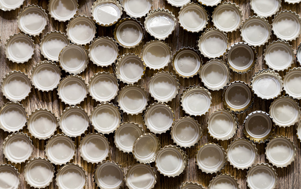 bottle caps lies on wood texture - Valokuva, kuva