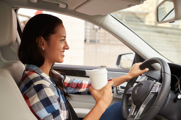 Female driver holding take away drink - Photo, Image