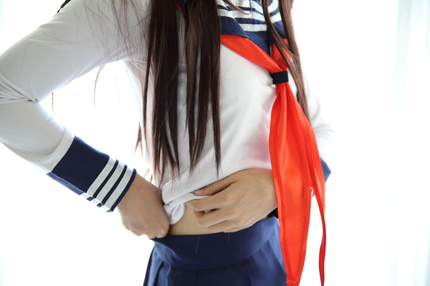 Asian school girl getting dressed - Photo, Image