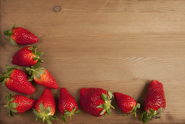 Ripe strawberries over wooden table background  - Photo, Image