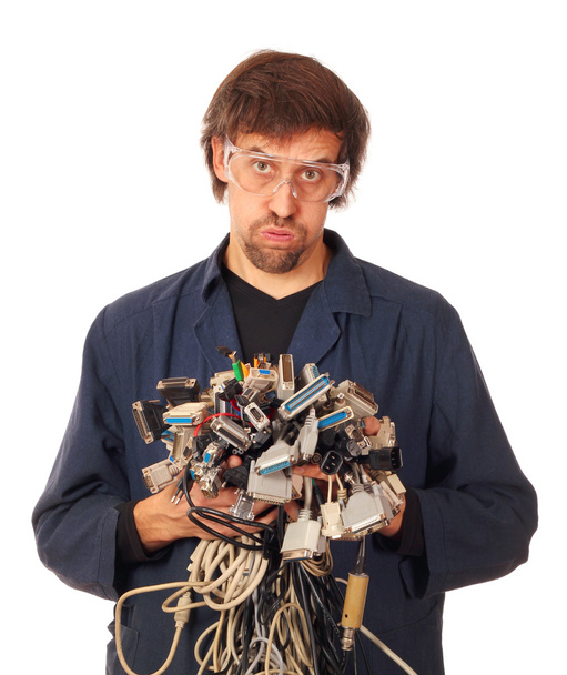 Tired computer engineer holding many different interface cables - Photo, Image