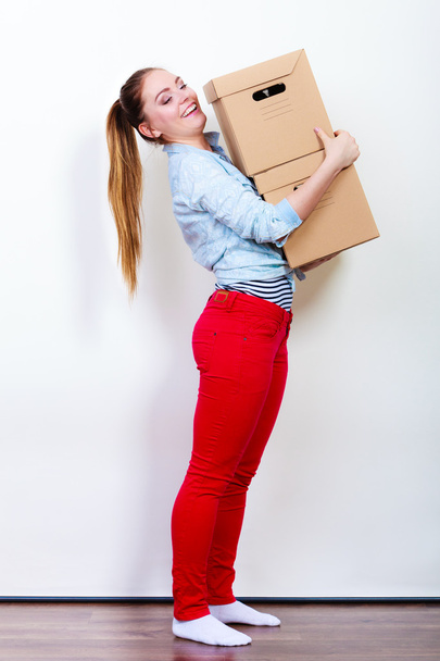 Woman moving in carrying carton boxes - Foto, imagen