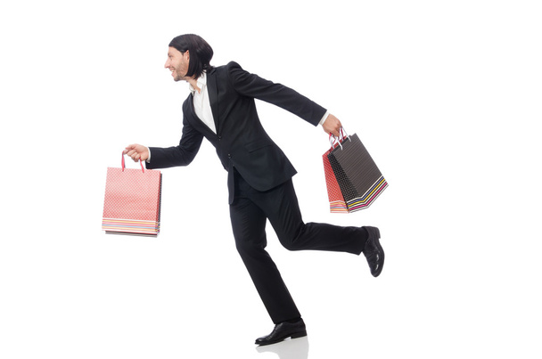 Black suit man holding plastic bags isolated on white - 写真・画像