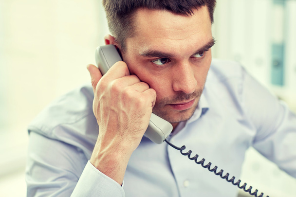 face of businessman calling on phone in office - Foto, Imagen
