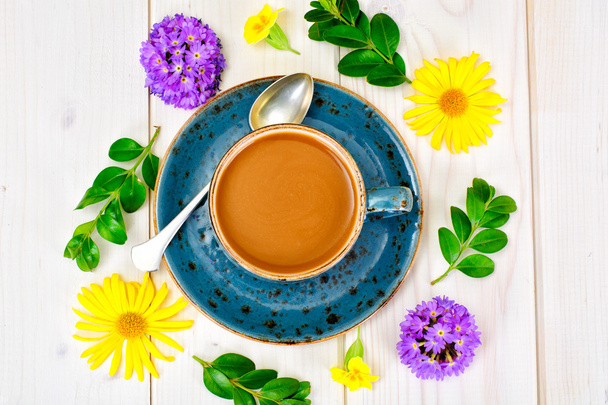 Coffee  in a blue retro cup with Flowers - Photo, Image