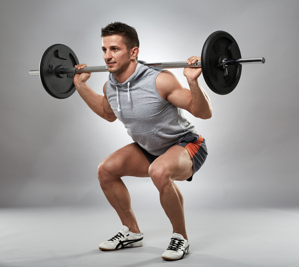 Man doing squats with barbell - Zdjęcie, obraz