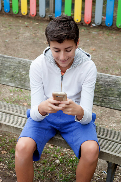 携帯で見ている 10 代の少年  - 写真・画像