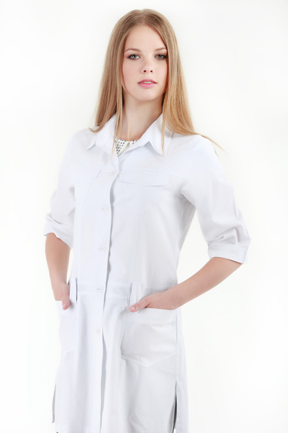 Smiling female doctor with a folder in uniform standing at hospi - Zdjęcie, obraz