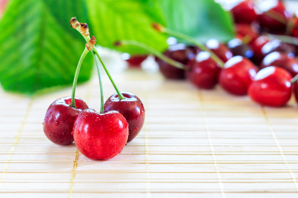 Cherries on wooden background - Photo, Image