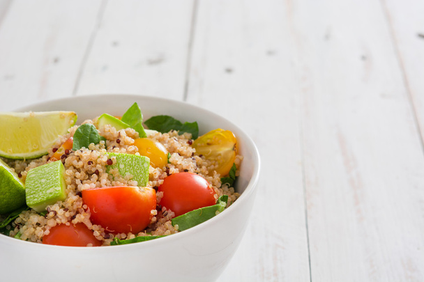 Quinoa, tomatoes and spinach on white wooden table - Photo, Image