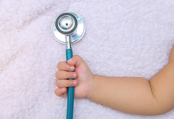 медицинские инструменты стетоскоп в руке новорожденной девочки
 - Фото, изображение