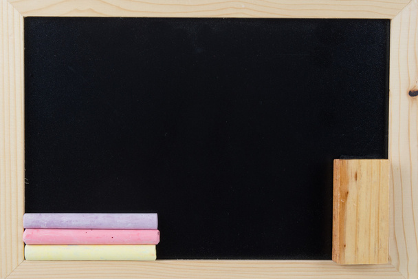 Small school wooden blank blackboard and chalks  - Photo, Image