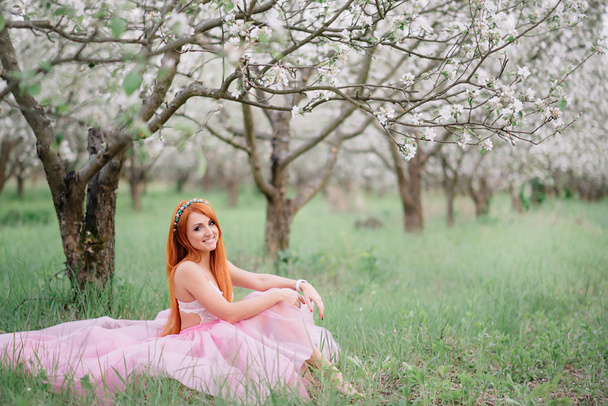 young beautiful woman in the lush spring garden - 写真・画像