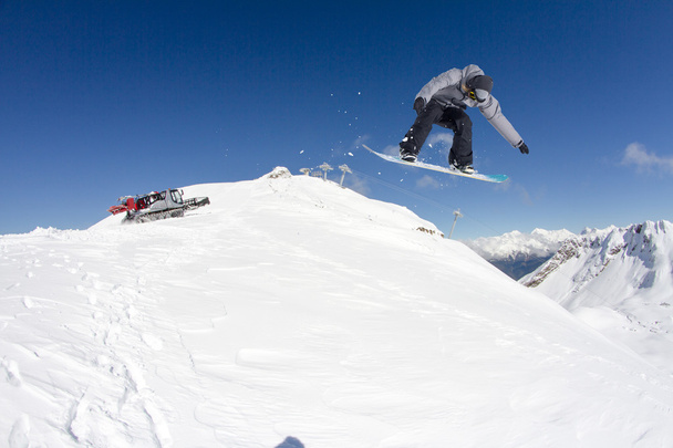 Cavaleiro de snowboard pulando em montanhas. Esporte de freeride de snowboard extremo. - Foto, Imagem
