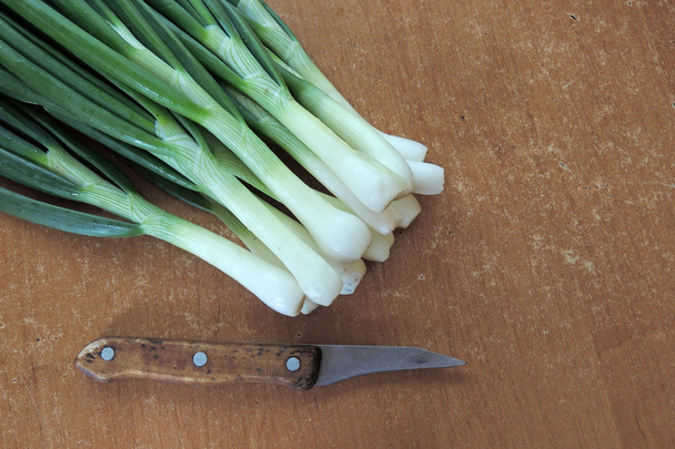 Green onions on a wooden table - Photo, Image