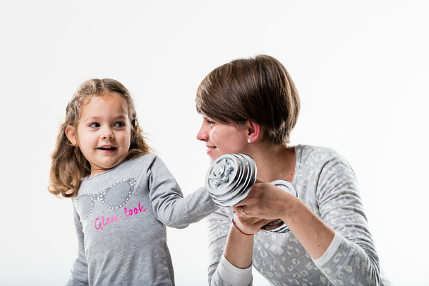 mother and daughter playing weight-lifting - Photo, Image