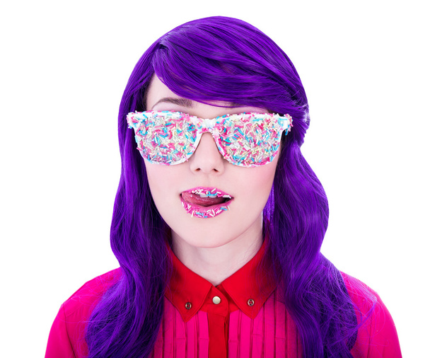 woman with purple hair and glasses covered by colorful sugar can - Photo, Image