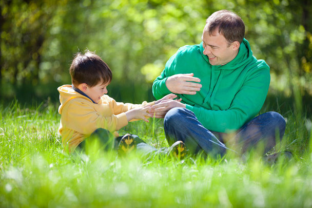 Happy father playing with his little son outdoors - Foto, Imagen