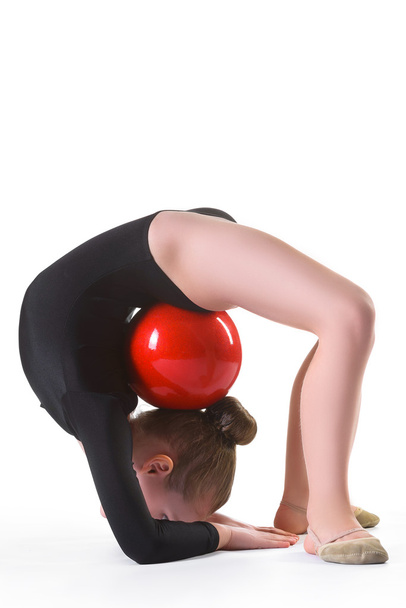 Girl doing gymnastic exercises or exercising on white background - Foto, imagen