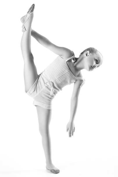 Girl doing gymnastic exercises or exercising on white background - Фото, изображение