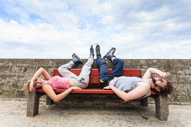 Young tired people friends relaxing on bench. - Φωτογραφία, εικόνα