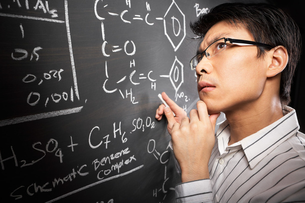 Male student working on equation - Foto, afbeelding
