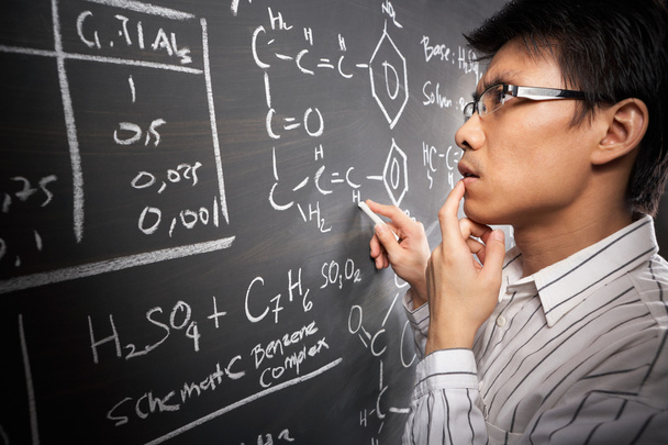 Male student working on equation - Foto, afbeelding