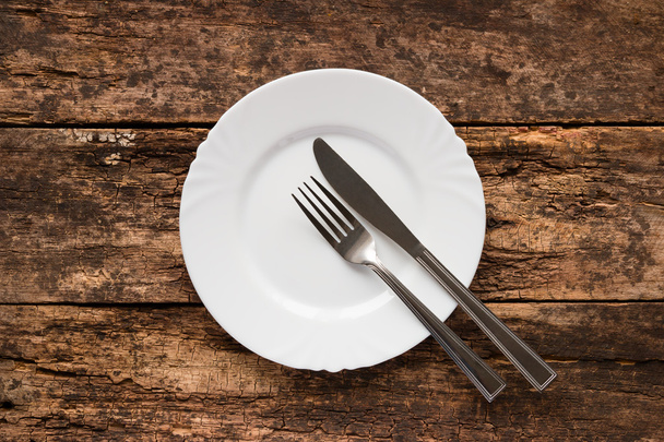 knife and fork on the plate are the symbol of the end - Foto, Imagem