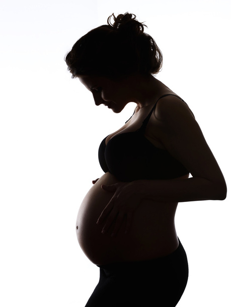 terhes nő arra törekszik, hogy a hasát - Fotó, kép