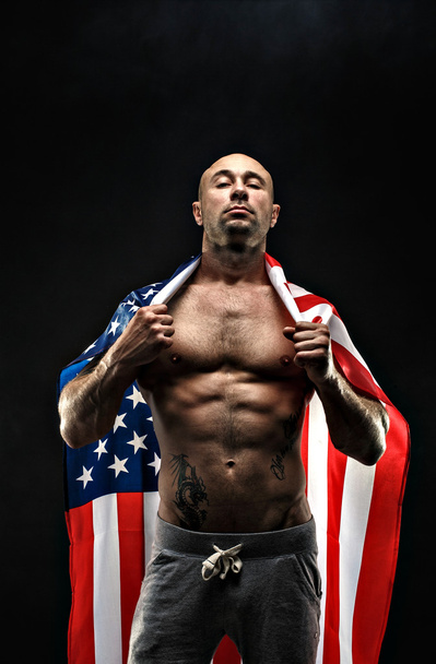 Handsome bald topless man with American flag on shoulders - Foto, imagen