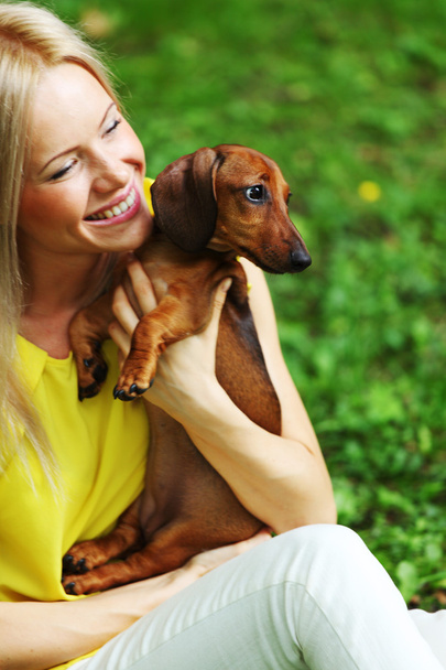 Woman dachshund in her arms - Photo, image