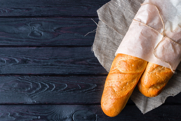 Bread in a paper bag on a napkin - Zdjęcie, obraz