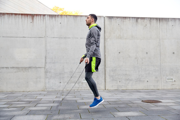 man exercising with jump-rope outdoors - Fotografie, Obrázek