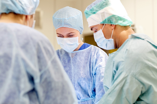 group of surgeons in operating room at hospital - Foto, Bild