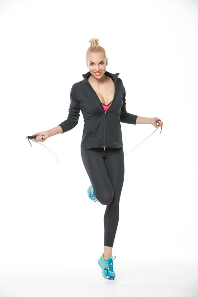 Blonde jumps with skipping rope - Foto, Imagen
