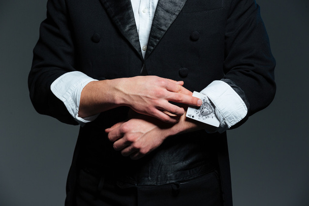 Closeup of man magician with ace in his sleeve - Fotoğraf, Görsel