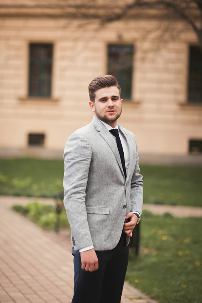 Handsome stylish young businessman posing portrait outdoor - Фото, изображение