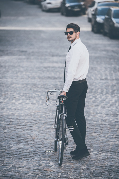 man rolling his bicycle outdoors - Valokuva, kuva