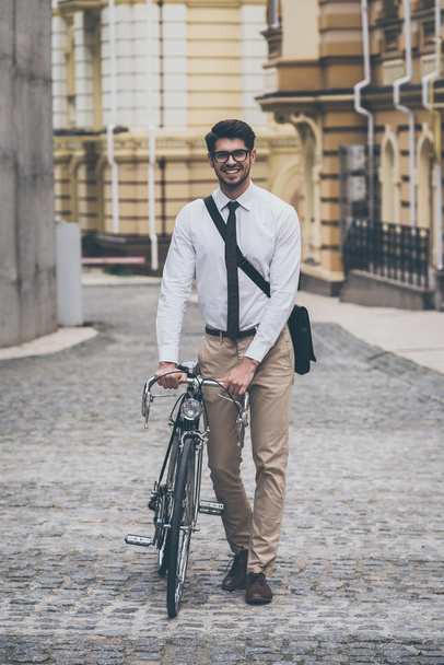man walking outdoors with bicycle  - Foto, afbeelding